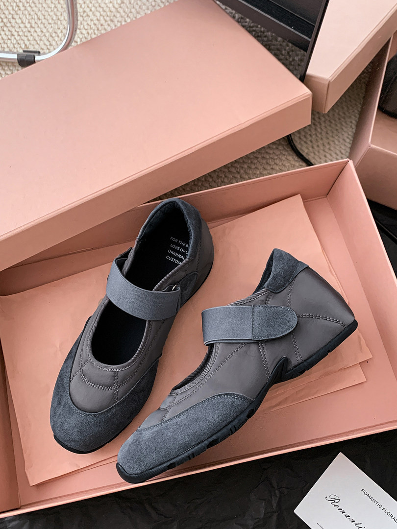 Pair of gray casual sneakers displayed in a shoebox