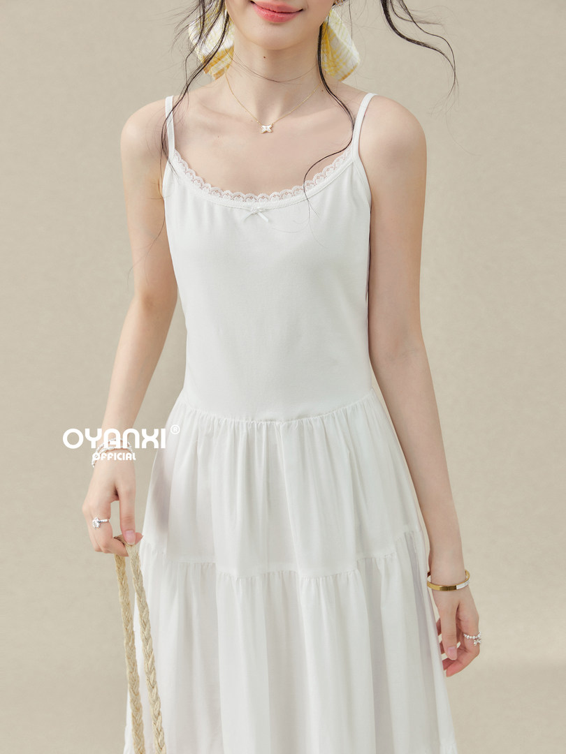 White sleeveless lace-trim dress on a model