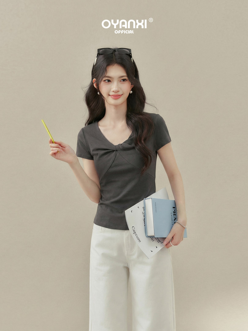 Model wearing a dark gray short-sleeve top with white wide-leg pants