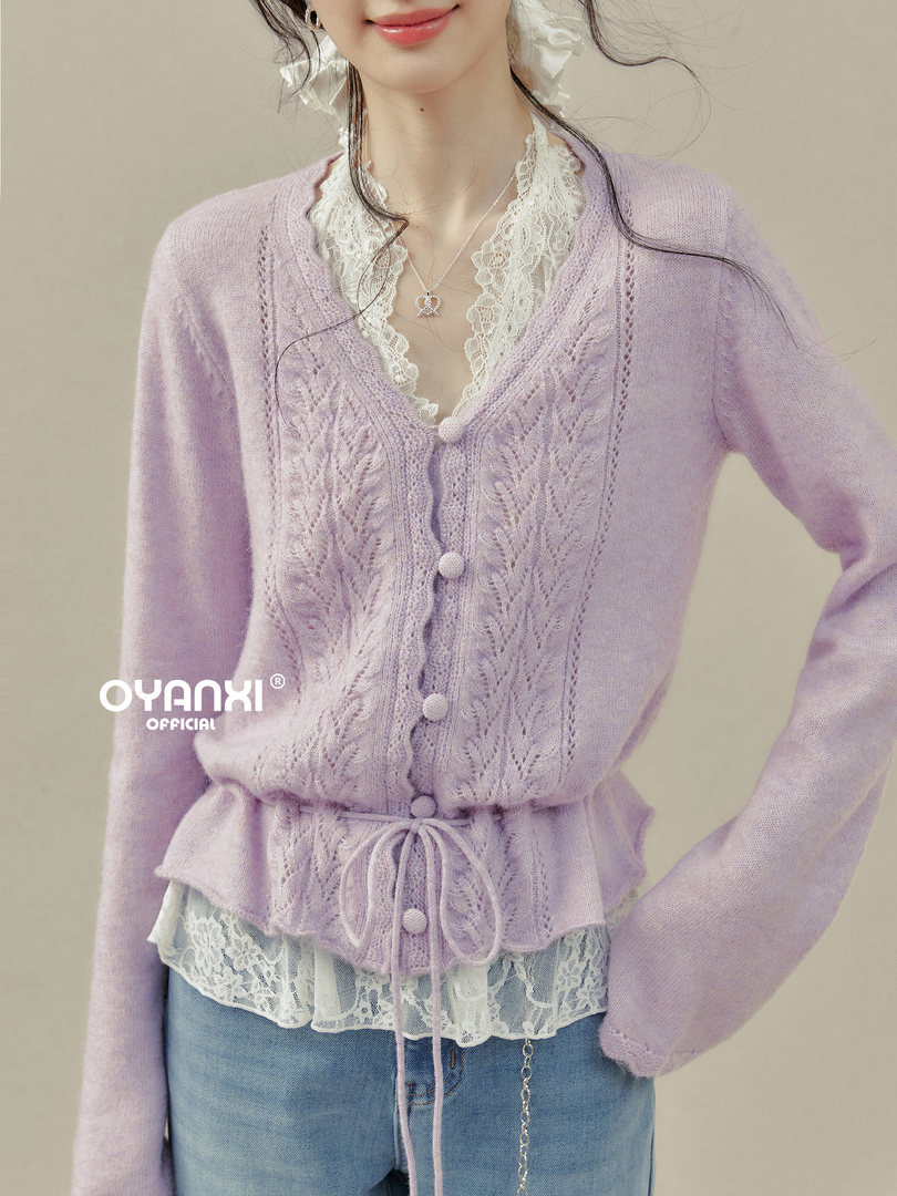 Lavender knit cardigan worn over a lace top with jeans