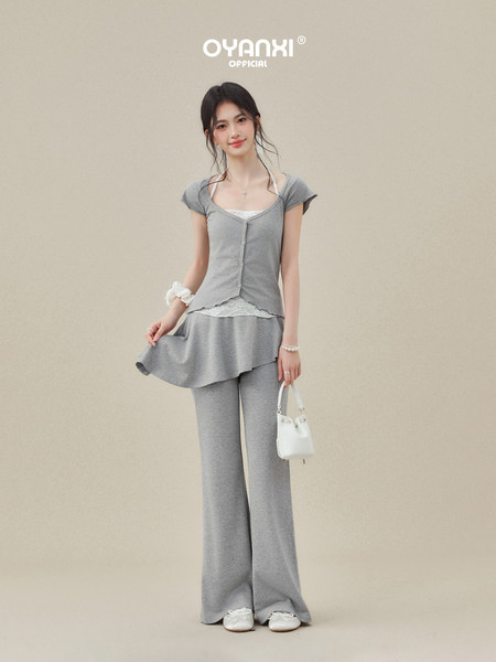 Model wearing a gray casual two-piece outfit with a short-sleeve top and wide-leg pants