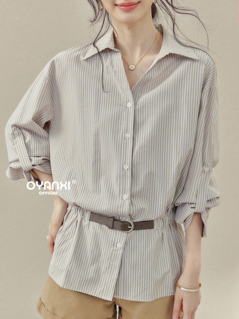 Model wearing a striped button-up shirt with a belt