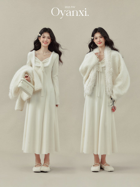 Cream midi dress with a white faux-fur outer layer worn by two models