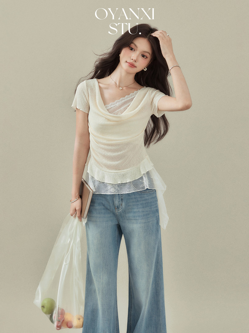 Model wearing a cream layered lace-trim top with light blue flared jeans