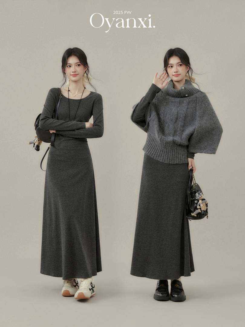 Two models wearing dark gray knit sweater dresses in a fashion promo image