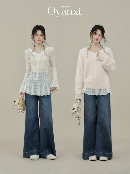 Two fashion models wearing layered knit tops with wide-leg jeans