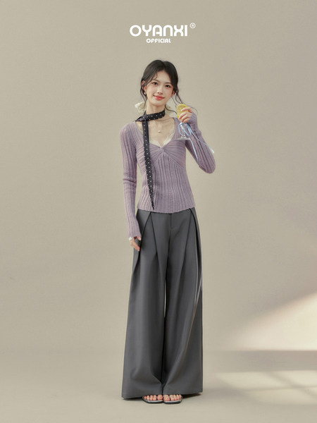 Model wearing a lilac ribbed long-sleeve top with wide-leg gray pants
