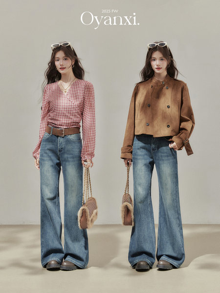 Two models wearing fall/winter fashion outfits with jeans and outerwear