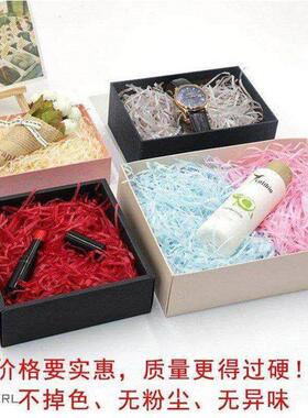 gift lined with shredded paper filling, colored packing box