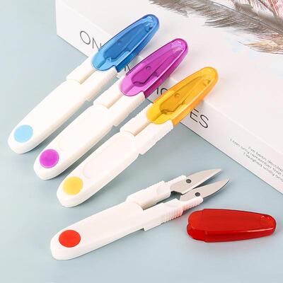 Origin of small sewing scissors, colorful transparent with a