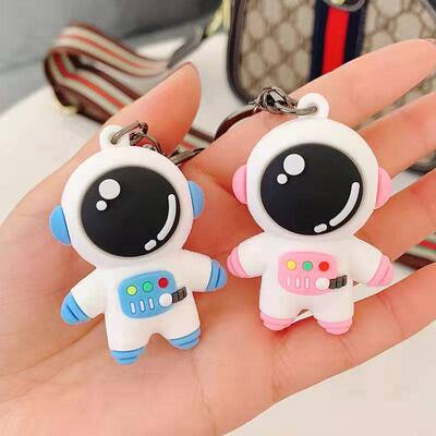Cartoon resin astronaut keychain with rocket and leather rop