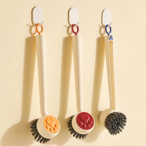 A long-handled brush for cleaning pots and pans, designed to