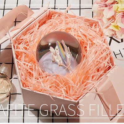 gift lined with shredded paper filling, colored packing box