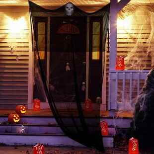 Halloween decorating a big skeletal mask and gargoyleing the