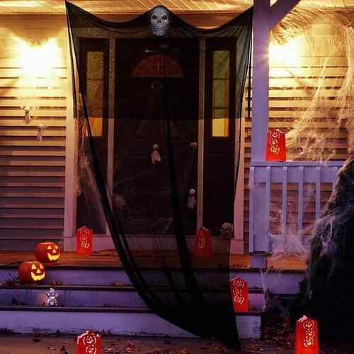 Halloween decorating a big skeletal mask and gargoyleing the