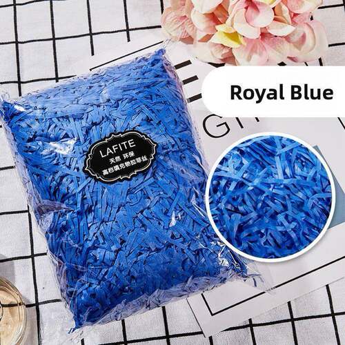 gift lined with shredded paper filling, colored packing box