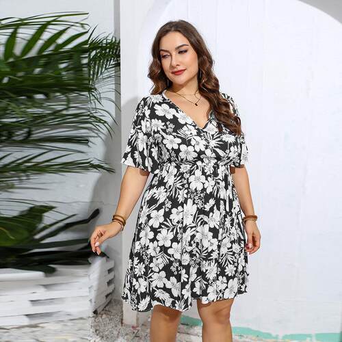 Large black and white printed style waist cinched dress