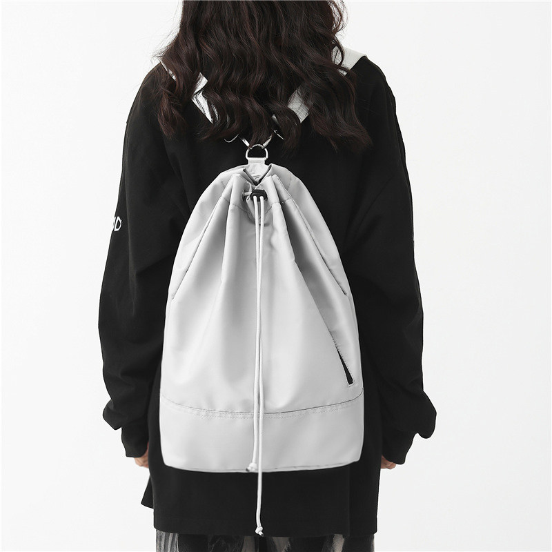 抽绳旅行双肩包男运动骑行侧揹包休闲上课通勤包女大学生百搭书包