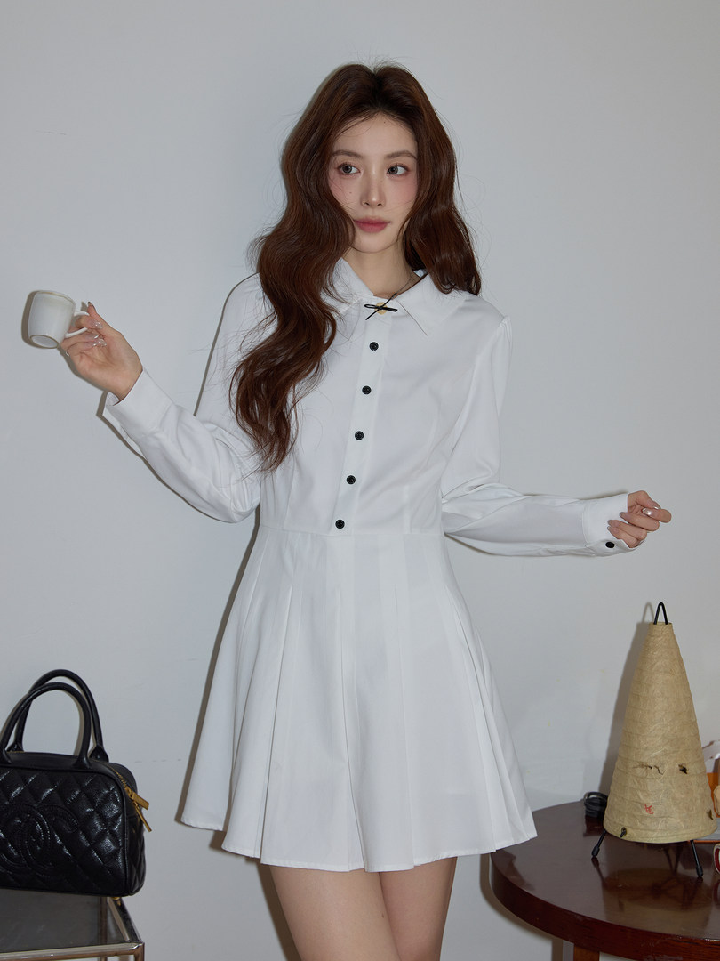 White long-sleeve collared dress worn by a model