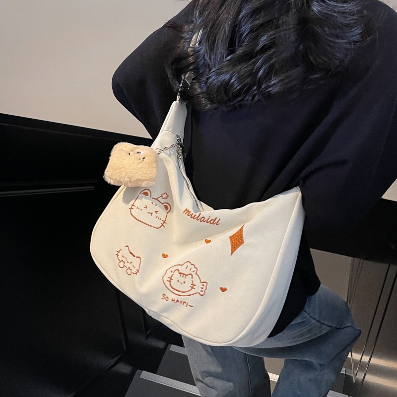 刺绣卡通磨砂包包女2025新款通勤单肩饺子包百搭大容量学生斜挎包