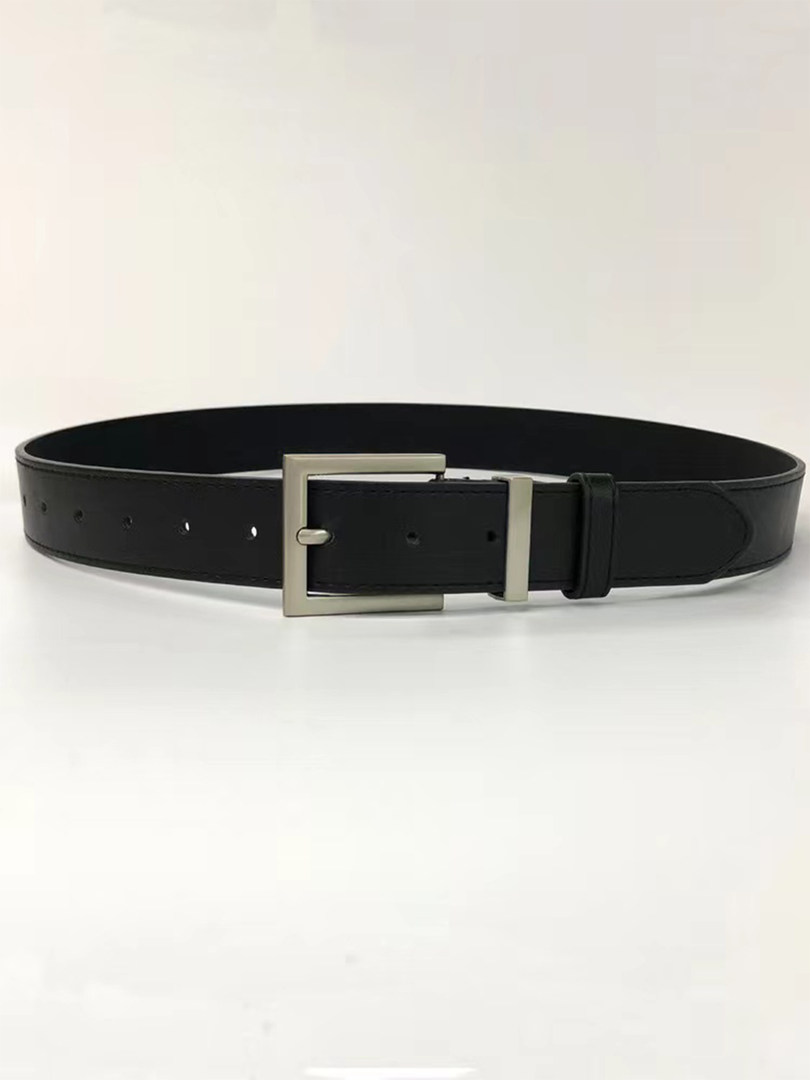 Black leather belt with silver buckle laid flat on a white background