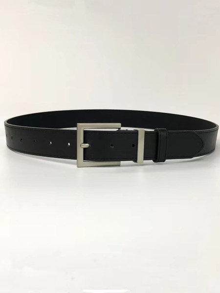 Black leather belt with silver buckle laid flat on a white background