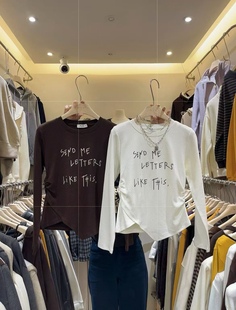 十三行2026春季新款韩版时尚百搭显瘦字母印花长袖不规则上衣女