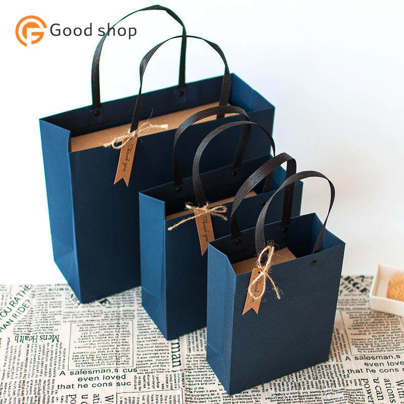 blue gift bag, simple paper bag, rivet in hand, gift box