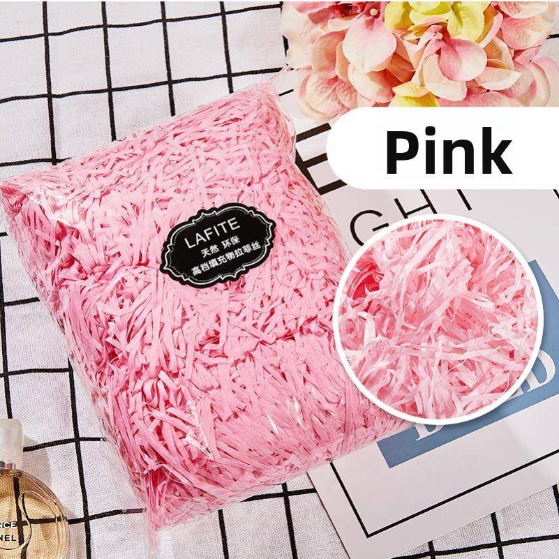 gift lined with shredded paper filling, colored packing box