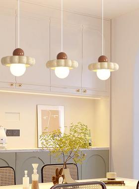 The chandeliers at the restaurant are red and warm for the b