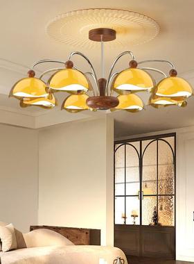 A modern, simple eye-shielded chandelier in the walnut wood-