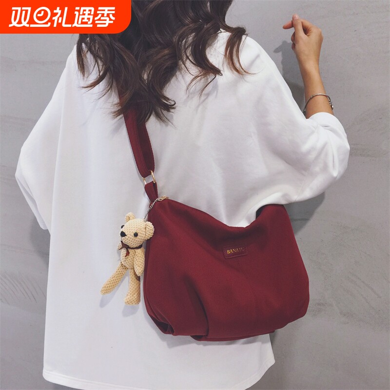 酒红色帆布包女2025新款上班通勤休闲饺子包大学生上课单肩斜挎包