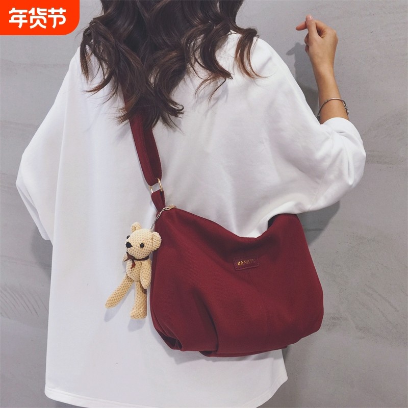 酒红色帆布包女2025新款上班通勤休闲饺子包大学生上课单肩斜挎包