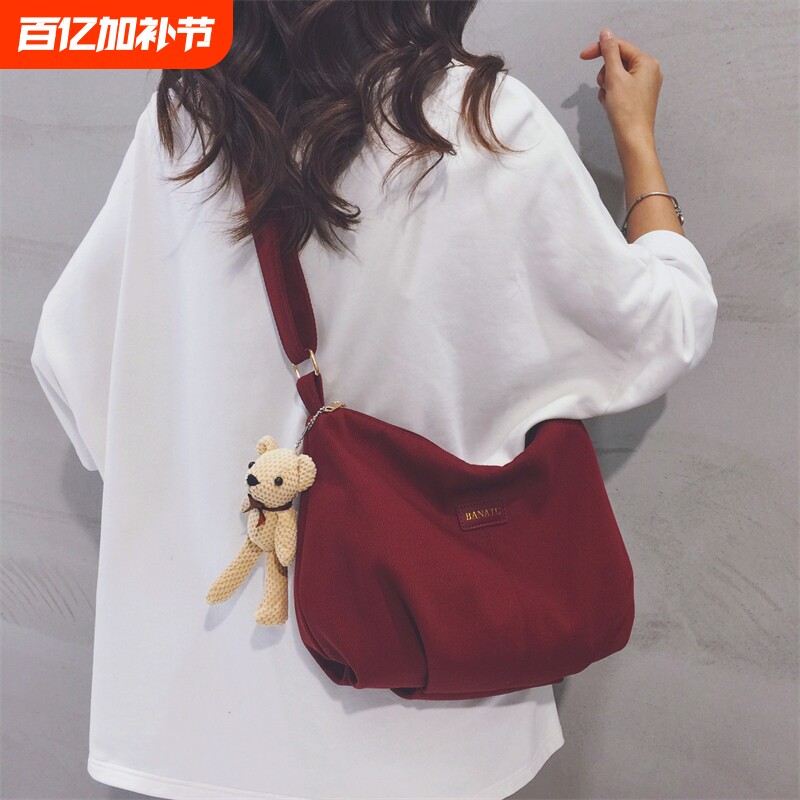 酒红色帆布包女2025新款上班通勤休闲饺子包大学生上课单肩斜挎包