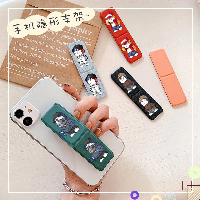 粘贴式手机磁吸车载懒人多功能支架防滑防摔背贴折叠支架机器猫