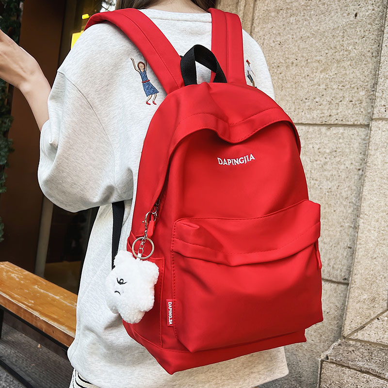 书包女大学生2025新款红色简约百搭旅行背包韩版高中大容量双肩包