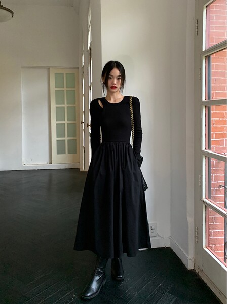 Black long-sleeve midi dress worn with black boots and a chain-strap bag