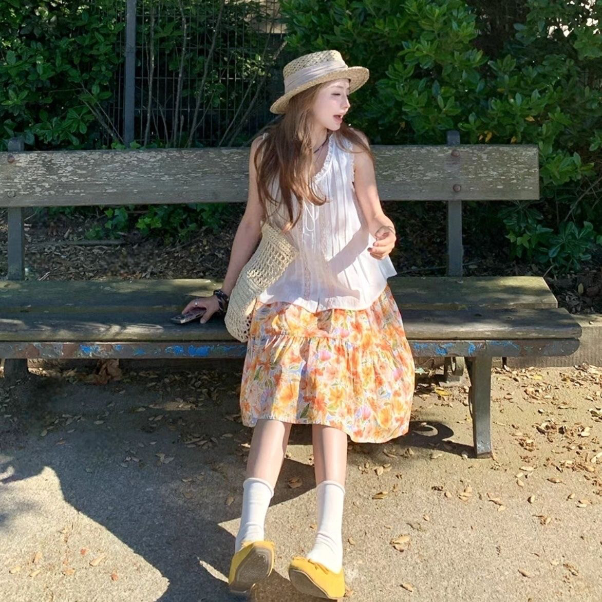 春秋橘子汽水2026橘色花朵中裙碎花大摆半身裙A字版甜美俏皮穿搭