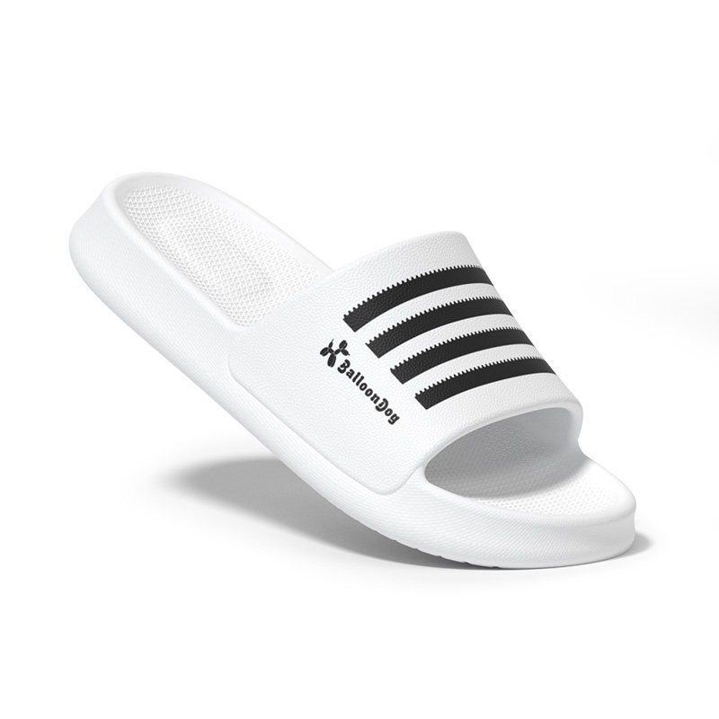 White slide sandal with black stripes on a white background