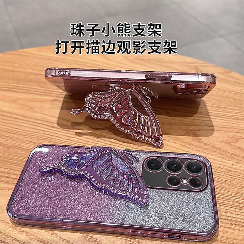 适用iPhone16手机壳苹果15电镀闪粉14镶钻流沙13蝴蝶支架2保护壳x