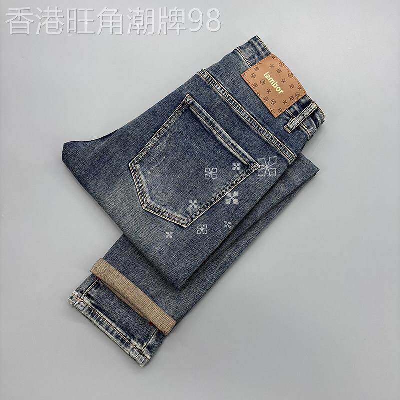 高端蓝色印花牛仔裤男2026秋季新款九分破洞补丁修身小脚弹力裤子