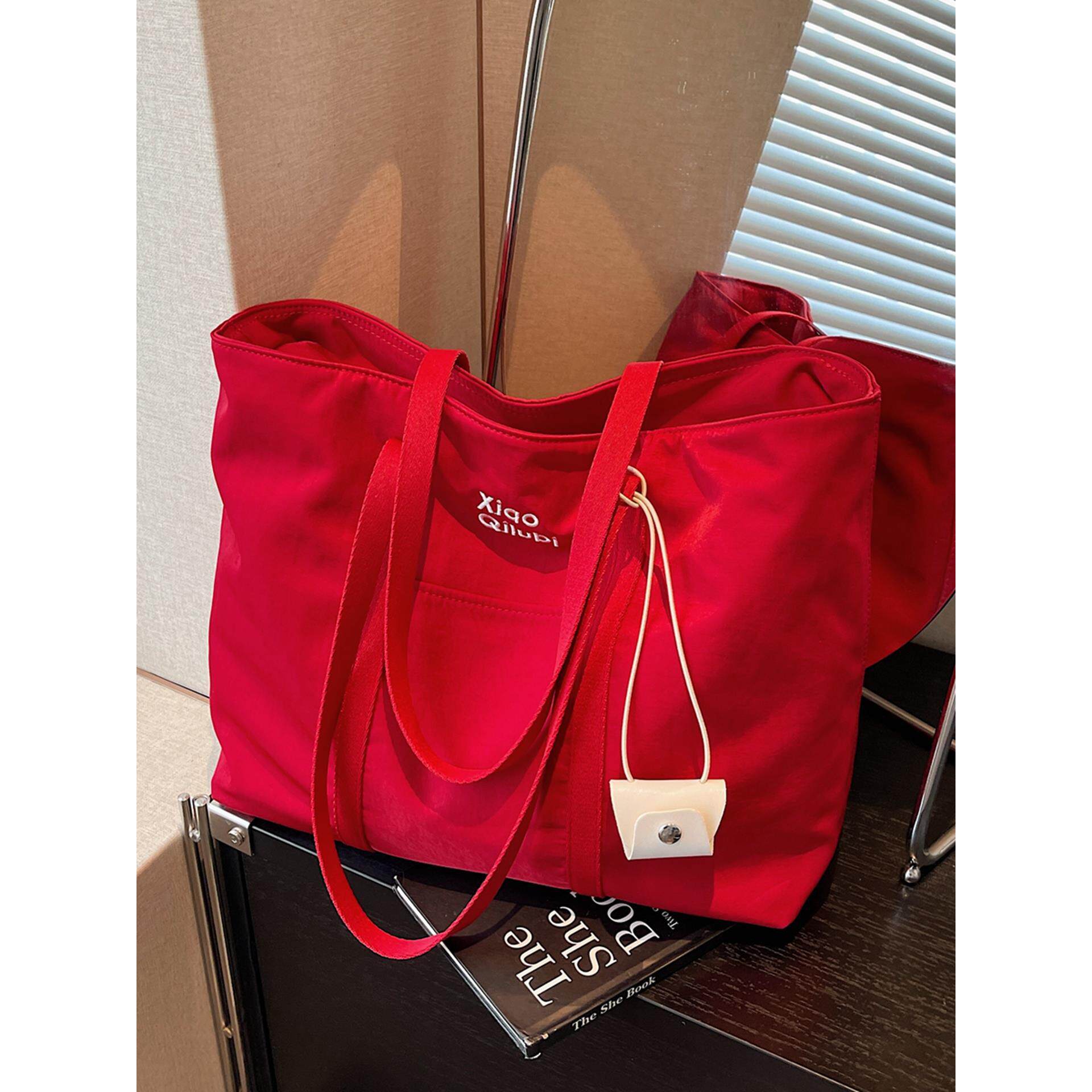 红色帆布包女2025新款休闲学生党通勤单肩包百搭轻便大容量托特包