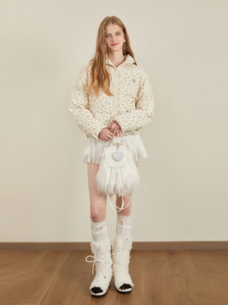 Model wearing a cream floral puffer jacket with a hood