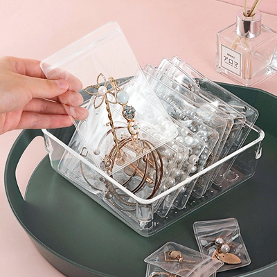 An oxidized jewelry box with earrings and earrings on the ne