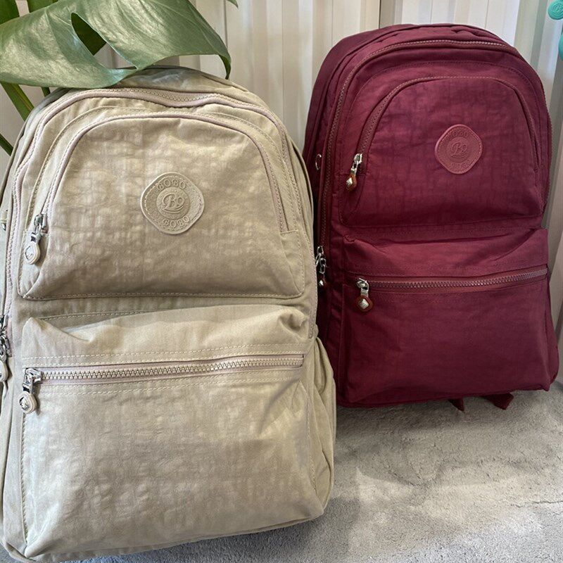 网红双肩包女大容量外出高级感旅游背包大学生书包男纯色百搭轻便