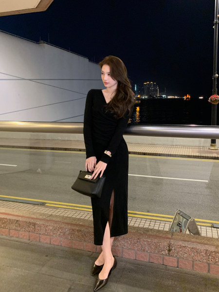 Black long-sleeve midi dress worn with a black handbag and heels at night