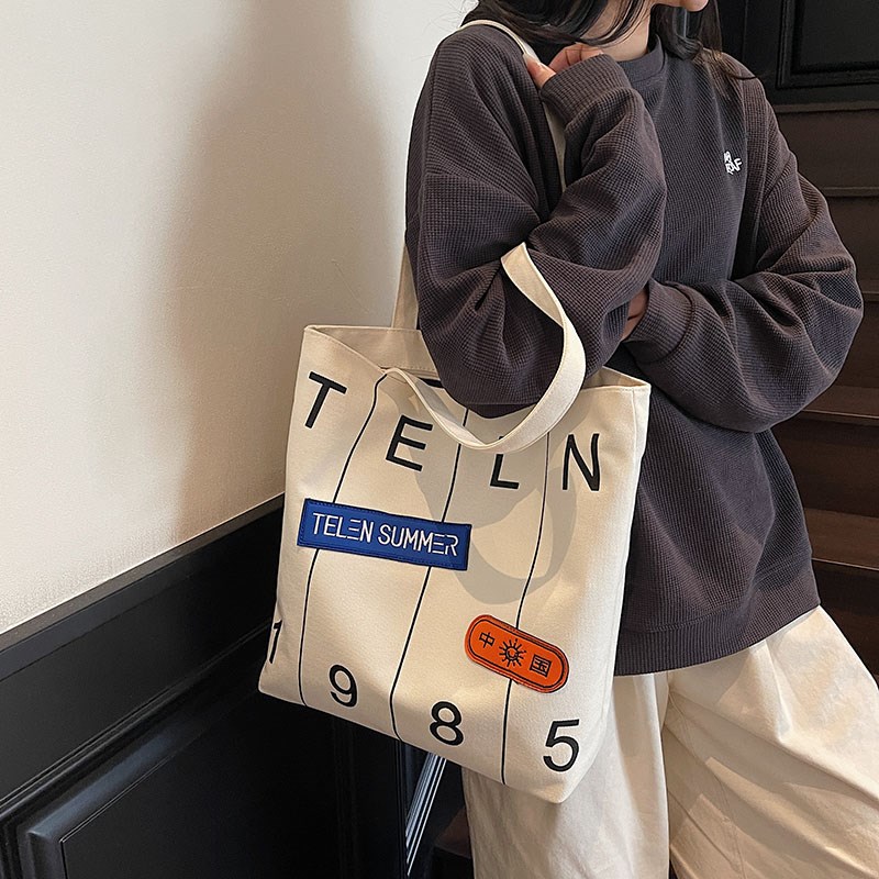 流行大容量帆布包女夏2025新款时尚百搭ins字母印花手提袋托特包