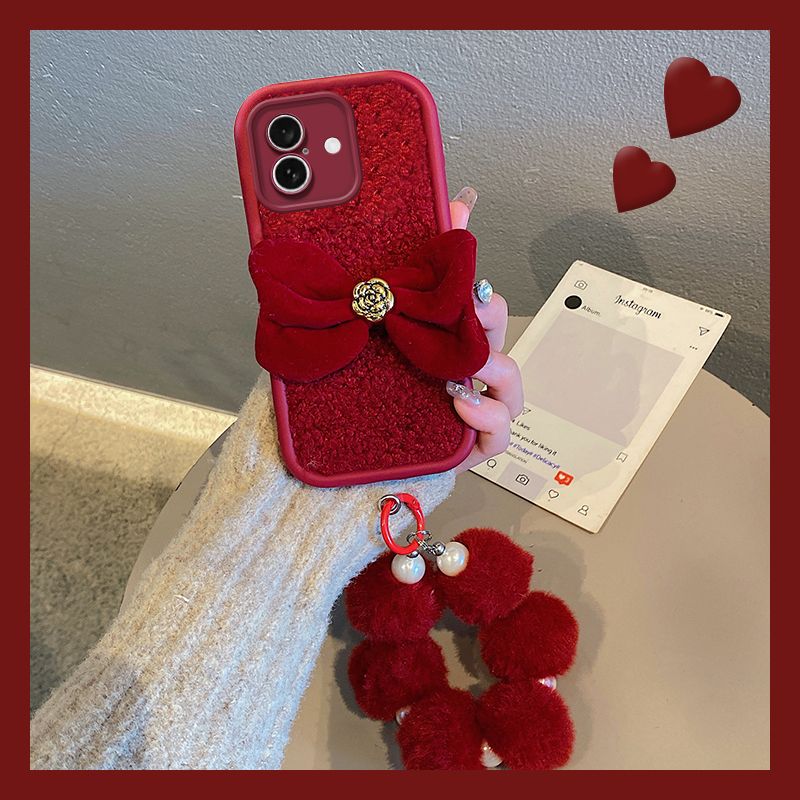 山茶花蝴蝶结适用苹果16手机壳iphone15pormax红色14毛球13挂链12日韩11pm立体ip毛绒por秋冬季手提新款毛毛p