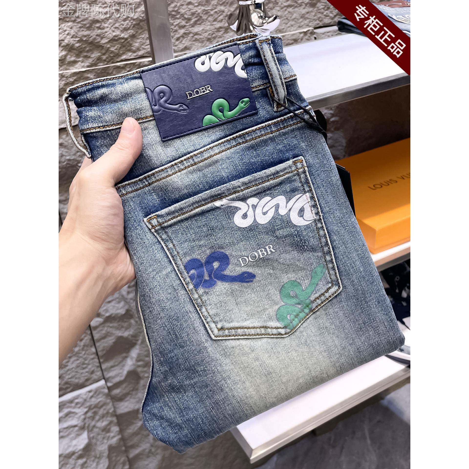 品牌专柜牛仔裤男士秋冬新款浅色高端轻奢修身小脚弹力印花长裤子