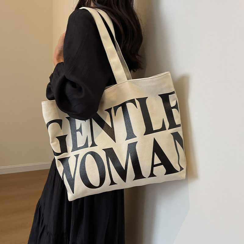 泰国小众字母帆布包女大容量2025新款手提袋通勤包百搭单肩托特包